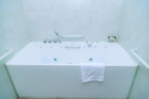 a white bathroom with a sink and a towel at Kigali Paramount Hotel in Kigali +24 photos