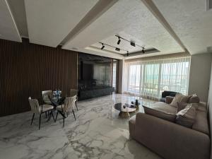 a living room with a couch and a table at Crowne Apartments in Mamaia