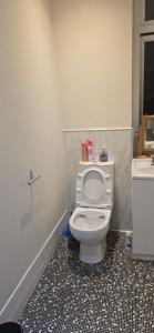a bathroom with a white toilet and a sink at Cosy 3 bedroom house in Leigh