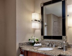 a bathroom with a sink and a large mirror at Loews New Orleans Hotel in New Orleans
