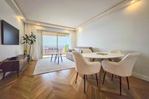 a living room with a table and chairs at Apartment 4 guests front of the sea in Antibes
