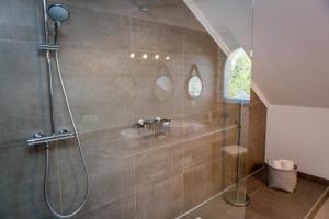 a bathroom with a shower with a sink and a glass shower at Villa la Vista in Lumio +89 photos