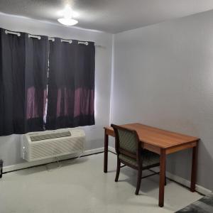 a room with a table and a chair and a window at 2 Full Bed Private Room 130 in Livingston