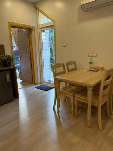 a dining room with a wooden table and chairs at Sea Breeze, Guhagar in Guhagar