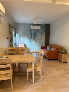 a living room with a table and chairs and a couch at Sea Breeze, Guhagar in Guhagar