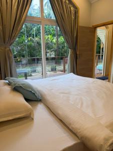 a large bed in a room with a large window at Sea Breeze, Guhagar in Guhagar