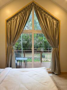 a bedroom with a bed and a large window at Sea Breeze, Guhagar in Guhagar
