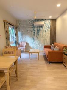 a living room with a couch and a table at Sea Breeze, Guhagar in Guhagar