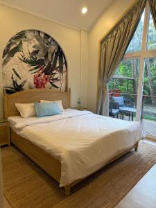 a bedroom with a large bed and a large window at Sea Breeze, Guhagar in Guhagar