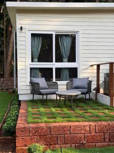 two chairs and a table in front of a house at Sea Breeze, Guhagar in Guhagar