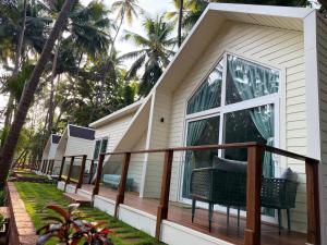 a house with a balcony with a window at Sea Breeze, Guhagar in Guhagar