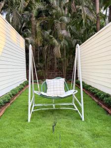 a hammock sitting on the grass in a yard at Sea Breeze, Guhagar in Guhagar