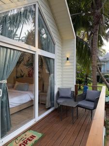 a porch with a bed and chairs on a house at Sea Breeze, Guhagar in Guhagar