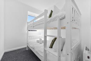 a white bunk bed in a white room at Cosy 3BR Urban Oasis in London in London