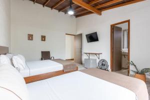 Postel nebo postele na pokoji v ubytování Hotel Prada