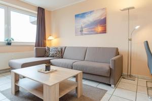 a living room with a couch and a coffee table at Haus Meeresgruß Relax in Grömitz