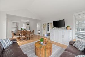 a living room with a couch and a table at The Kiskadee - 49 Butternut in Cherry Valley