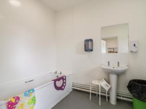 a bathroom with a sink and a mirror at Dozy Dotty Cow Shed 4 in Woodbridge +16 photos