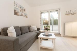 a living room with a couch and a table at Ferienwohnung Jankar in Timmendorfer Strand
