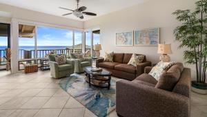 a living room with couches and a view of the ocean at Kapalua Bay Villa 17B4 in Kapalua