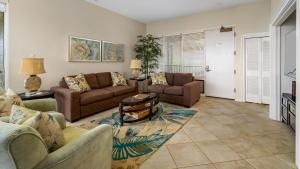 a living room with two couches and a table at Kapalua Bay Villa 17B4 in Kapalua