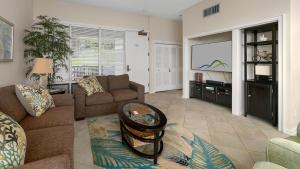 a living room with a couch and a flat screen tv at Kapalua Bay Villa 17B4 in Kapalua +35 photos