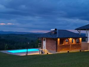 a house with a swimming pool at night at Vikendica sa bazenom Staša in Banja Luka