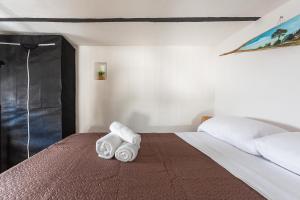 a bedroom with a bed with towels on it at La Casetta a Sannicola by BarbarHouse in Sannicola