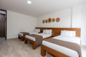 Postel nebo postele na pokoji v ubytování Hotel Prada