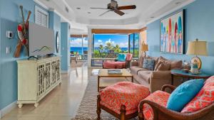 a living room with a couch and a tv at Kapalua Bay Villa 18G2 in Kapalua