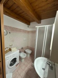 a bathroom with a toilet and a sink and a washing machine at Affaccio sul Mare in Tropea +11 photos