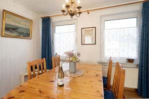 a dining room with a wooden table and chairs at Ferienhaus Seepferdchen in Fehmarn