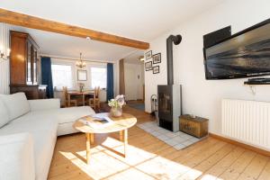 a living room with a white couch and a table at Ferienhaus Seepferdchen in Fehmarn