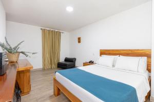 Postel nebo postele na pokoji v ubytování Hotel Prada