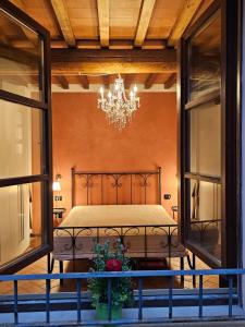 a bedroom with a bed and a chandelier at Tuscany Hill in Gambassi Terme +11 photos