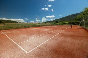 a tennis court with a net on it at Appartement dans l'aile du château 130M2 6 personnes in Carcassonne