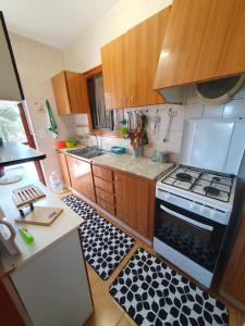 a small kitchen with a stove and a sink at Casa Estela in Alcanar