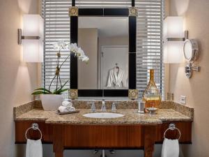 a bathroom with a sink and a mirror at Loews New Orleans Hotel in New Orleans +86 photos