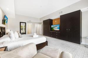 a bedroom with a large bed and a tv at Exclusive Doral Villa with Luxury Amenities in Miami +19 photos