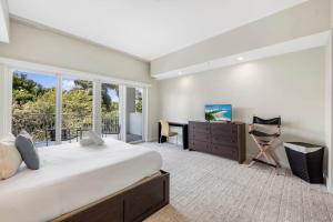 a bedroom with a bed and a desk and a window at Exclusive Doral Villa with Luxury Amenities in Miami