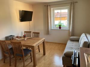 a living room with a table and a couch at Wohnung mit Bergblick in Waging am See