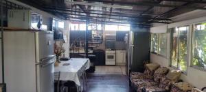 a kitchen with a table and chairs in a room at Habitacion Donde Emita in Santiago +10 photos