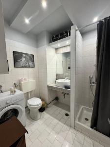 a bathroom with a toilet and a sink and a shower at Delfi Home in Samos +9 photos