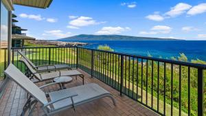 a balcony with chairs and a view of the ocean at Kapalua Bay Villa 21G2 in Kapalua