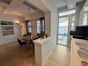 a kitchen and living room with a table and a dining room at Delfi Home in Samos