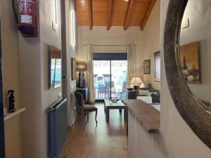 a hallway with a mirror and a living room at Descanso de posada in Posada de Llanes