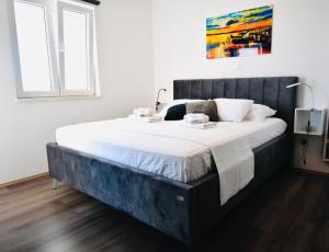 a bedroom with a large bed with white sheets at Dubrovnik Icy Guest House in Dubrovnik