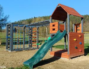 a playground with a slide and a play structure at Widokówka Myczkowce in Myczkowce