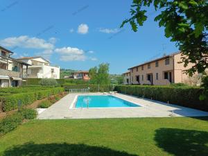 a swimming pool in the backyard of a house at Appartamento Orchidea Garda in Garda