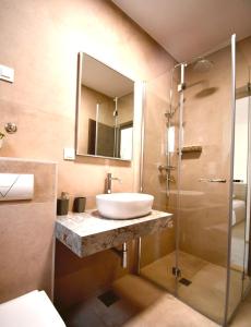 a bathroom with a sink and a shower at Dubrovnik Icy Guest House in Dubrovnik